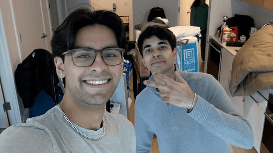Rohan Vasishth and Faraz Siddiqi, co-founders of Bluejay AI, smiling in a room that appears to be their 'hacker house